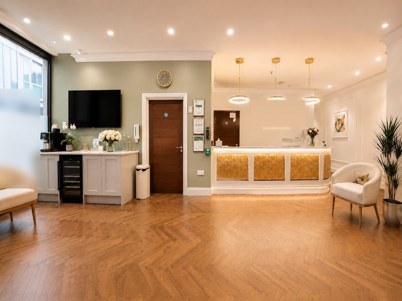MHW Clinic reception &mdash; herringbone parquet floor, warm pendant lighting, comfortable waiting area